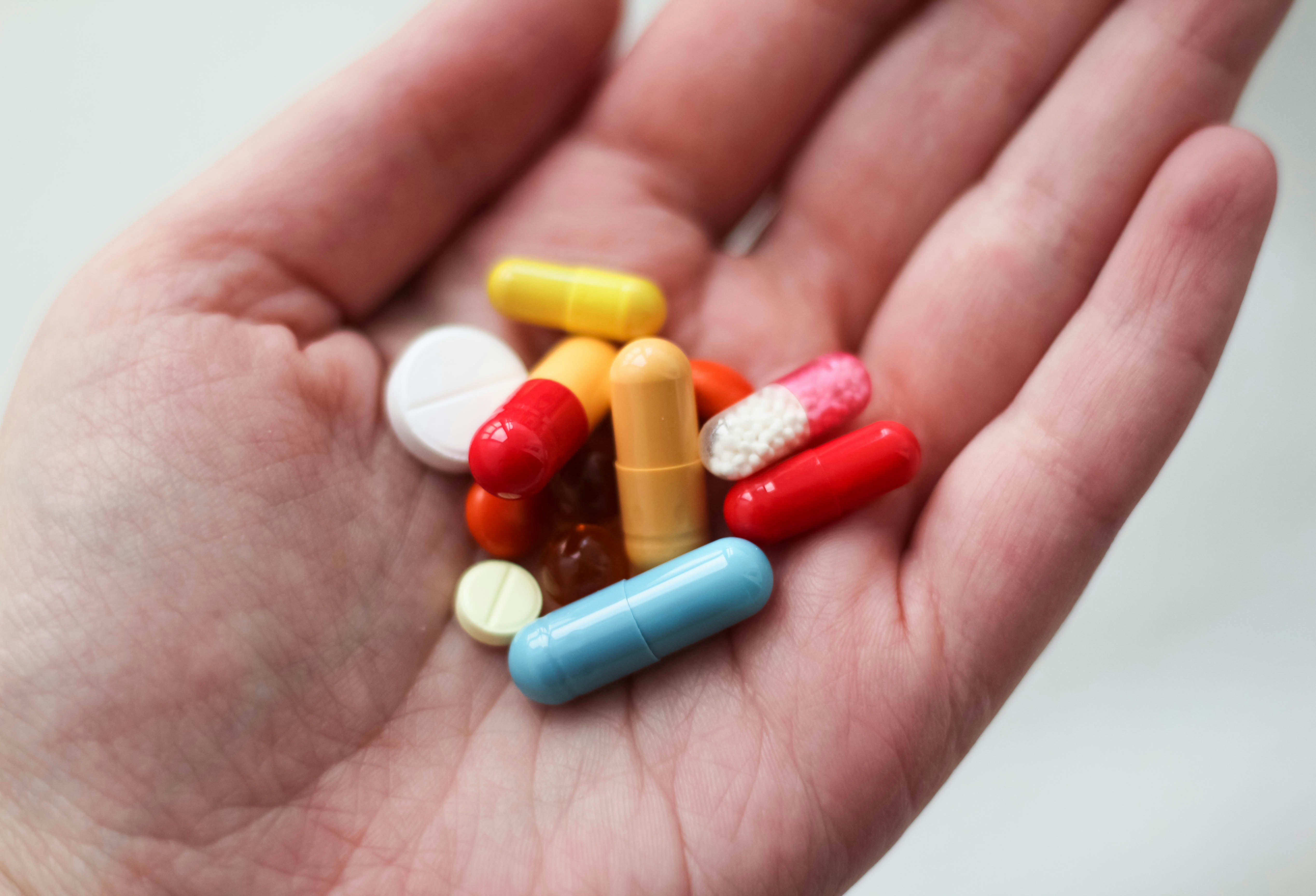 A handful of pills representing controlled substances.